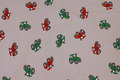 Light grey cotton-jersey with small red and green tractors Light grey cotton-jersey with small red and green tractors