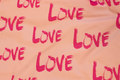 Delicate light red cotton-jersey with pink love-motif Delicate light red cotton-jersey with pink love-motif