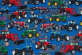 Blue cotton-jersey with tractors in red, green and blue Blue cotton-jersey with tractors in red, green and blue