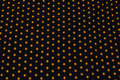 Black cotton-jersey with orange stars on ca. 1 cm Black cotton-jersey with orange stars on ca. 1 cm