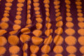 Felt wool in bordeaux with 2-5 cm orange dots