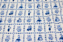 Firm, white cotton with blue sqaure-pattern with motifs