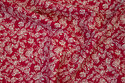 Red, firm cotton with off white flowers