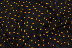Light, black blusesatin with 8 mm orange dots