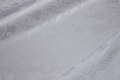 White jacquard-woven polyester satin with paisley-pattern