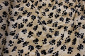 Beige faux pelsstof with black paws