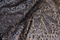 Beautiful net-fabric, in dark brungrå, with sewn-on sequins