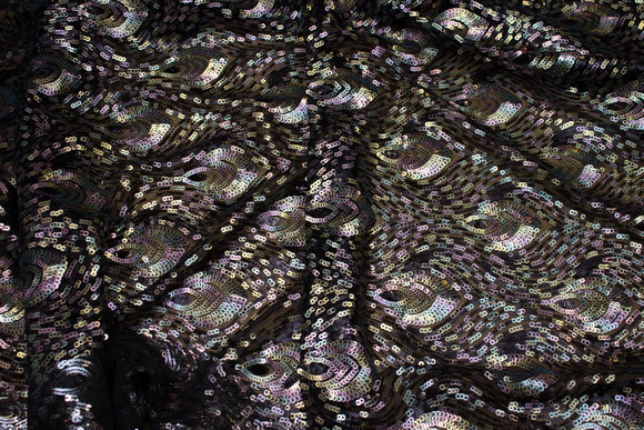 Beautiful sequins-fabric with peacock-pattern on black base of mesh