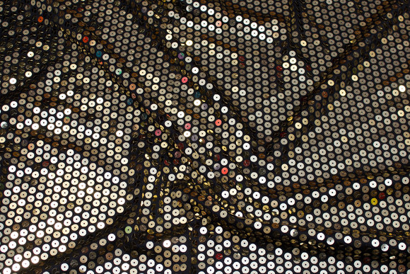 Stretch-sequins-fabric in black with big sewn-on gold sequins