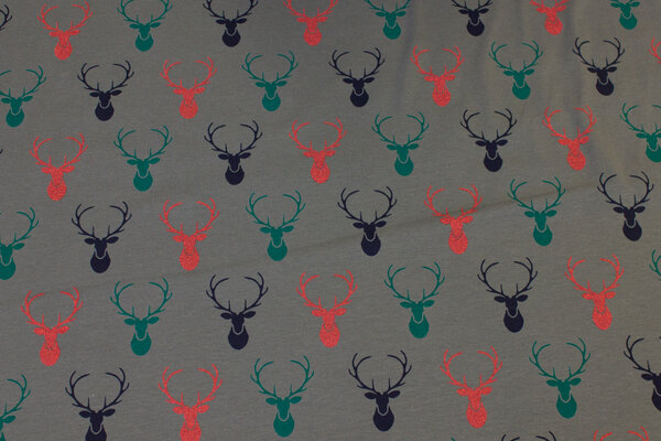 Dark grey cotton-jersey with ca. 4 cm dear-heads in navy and green and red