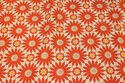 Medium-thickness linen-look with ca. 8 cm orange-red flowers