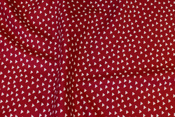 Dark red cotton with small white triangles