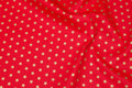 Rugged red deko-cotton with 1 cm gold stars