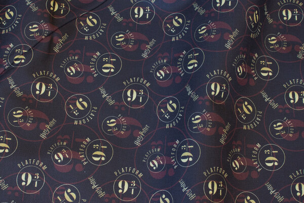 Medium-thick cotton in black with Harry Potter 9-3-4 motif