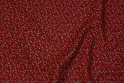 Dark red cotton with small green leaf-pattern