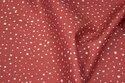 Organic cotton in brick-red with white dots