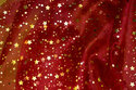 Wine-red, transparent organza with 1-1½ cm gold stars